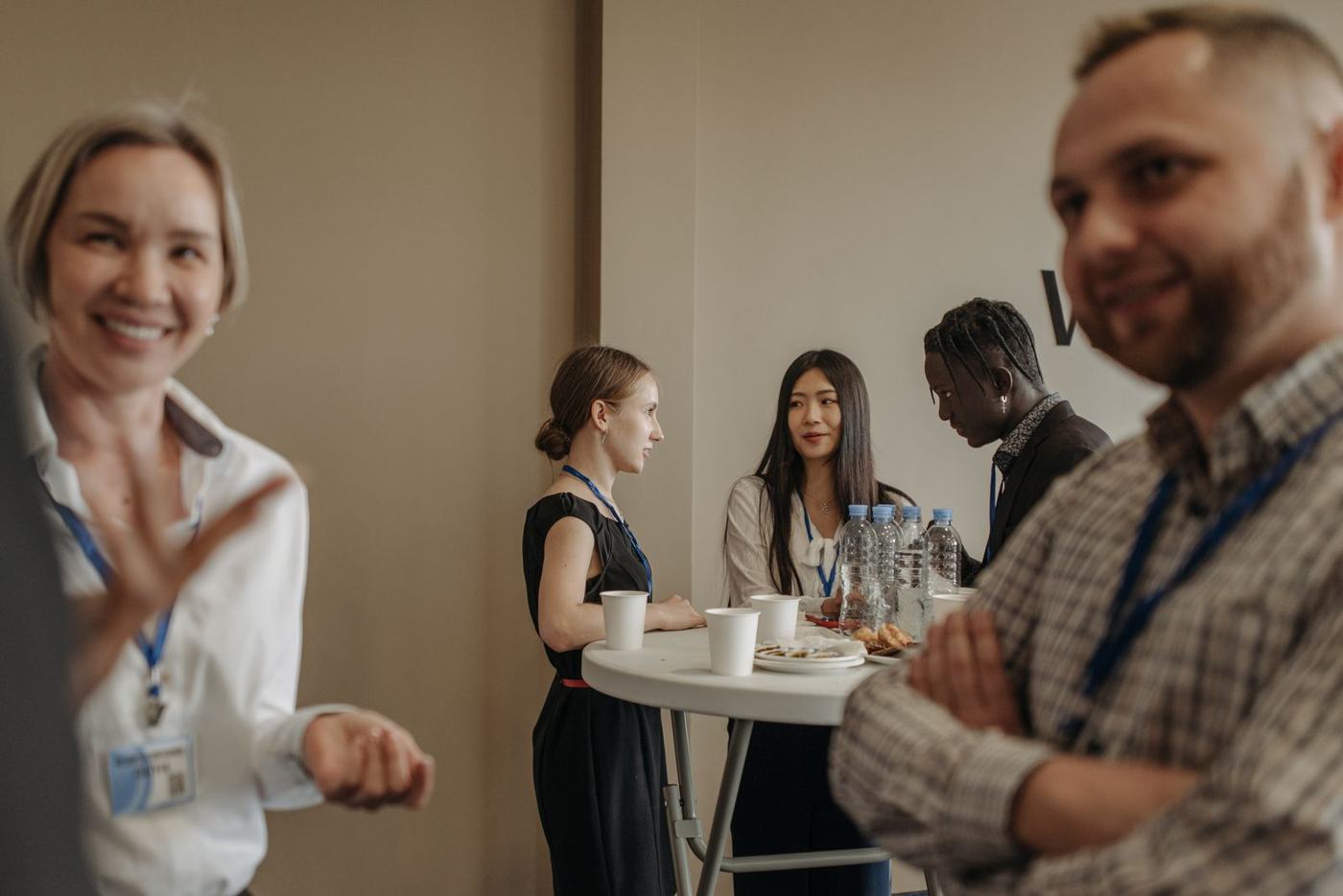People talking over coffee at a networking break